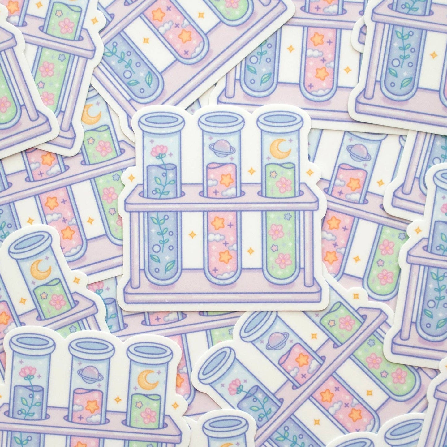 Pattern of test tubes and test tube racks with colorful liquids and flowers on a light background.