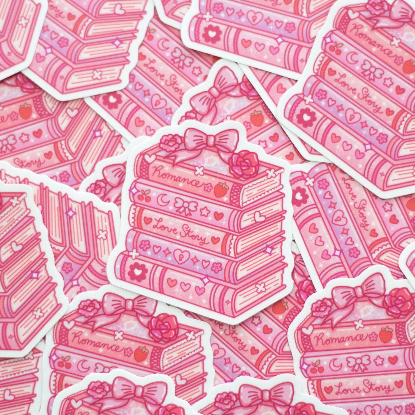 Pink stickers with cake and book design, featuring the word 'Romance'.