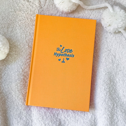 Orange book with 'the Love Hypothesis' text on a textured surface