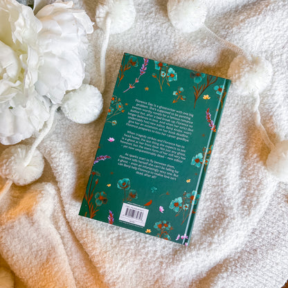 Book with floral design on a textured surface with white flowers