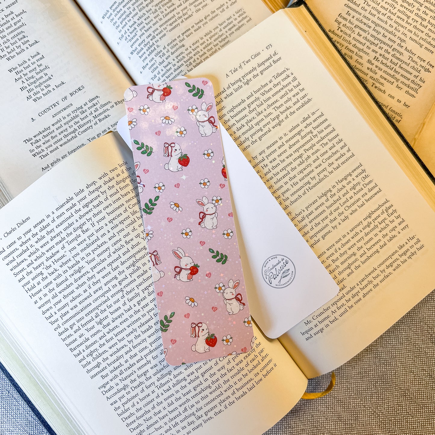 Pink floral bookmark with bunnies on an open book