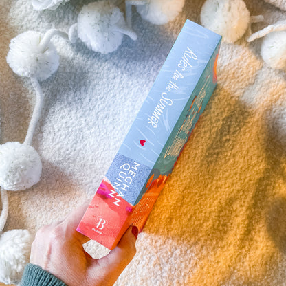 The spine of the book "rules for the summer" on a textured white background.