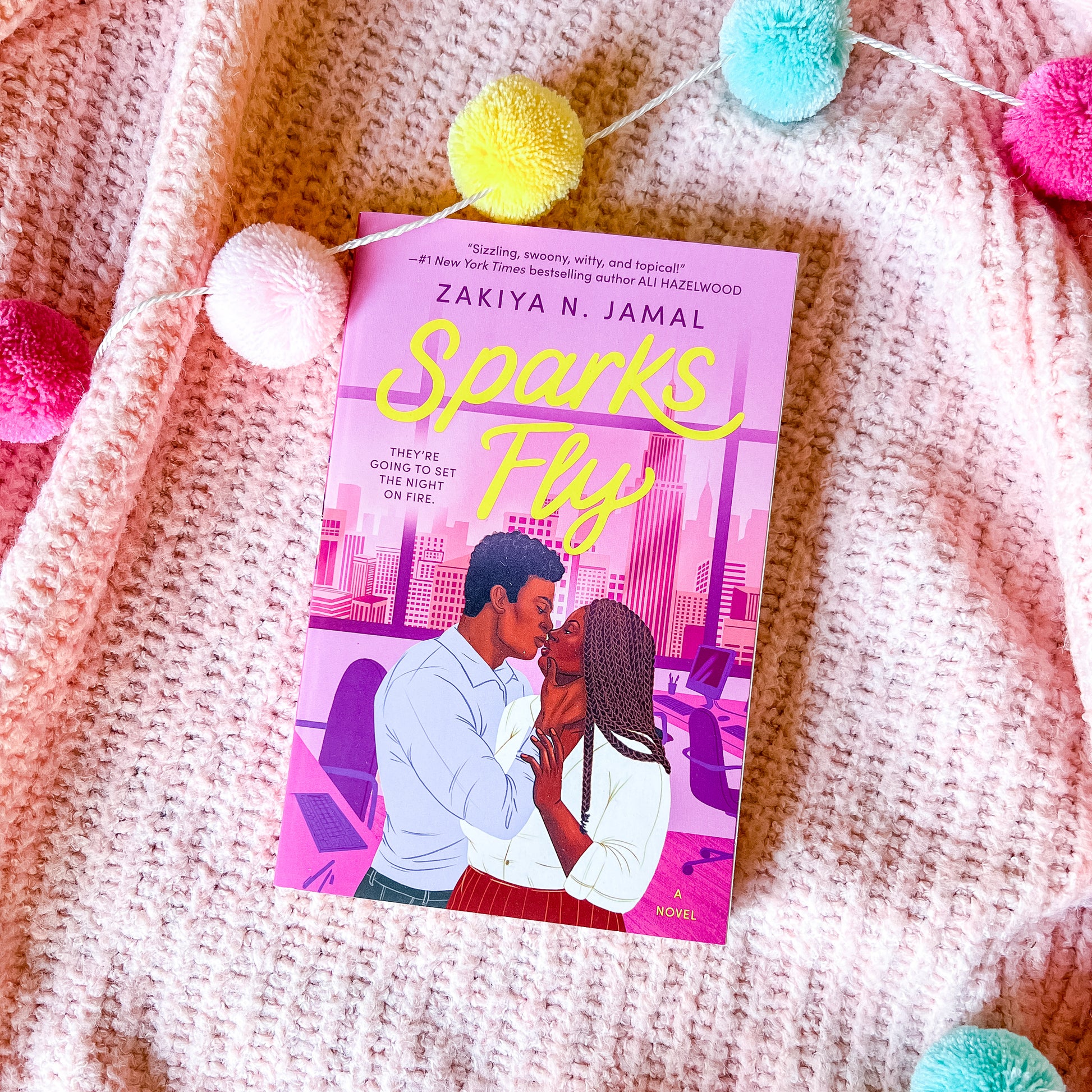 "Sparks fly" book by Zakiya N Jamal, which shows a couple embracing, on a pink background