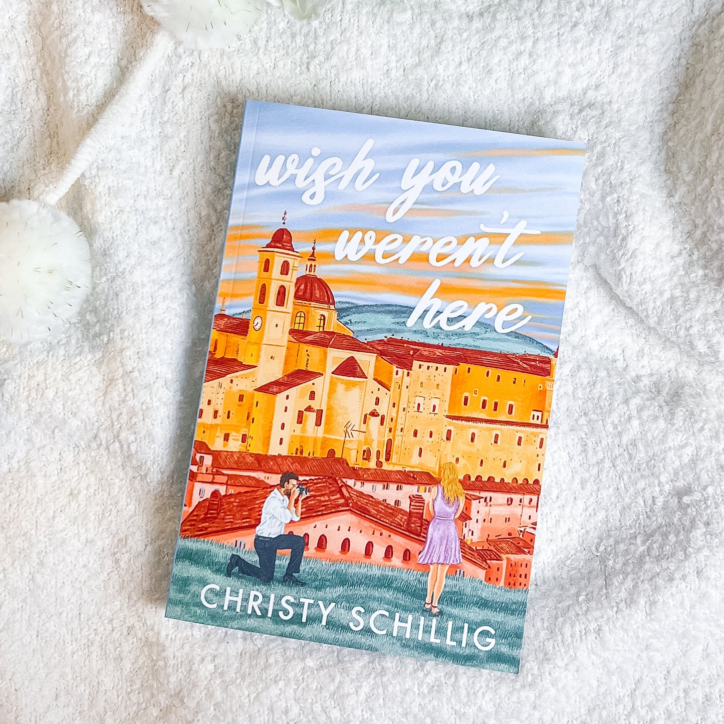 Book titled 'wish you weren't here' by Christy Schillig on a soft white surface