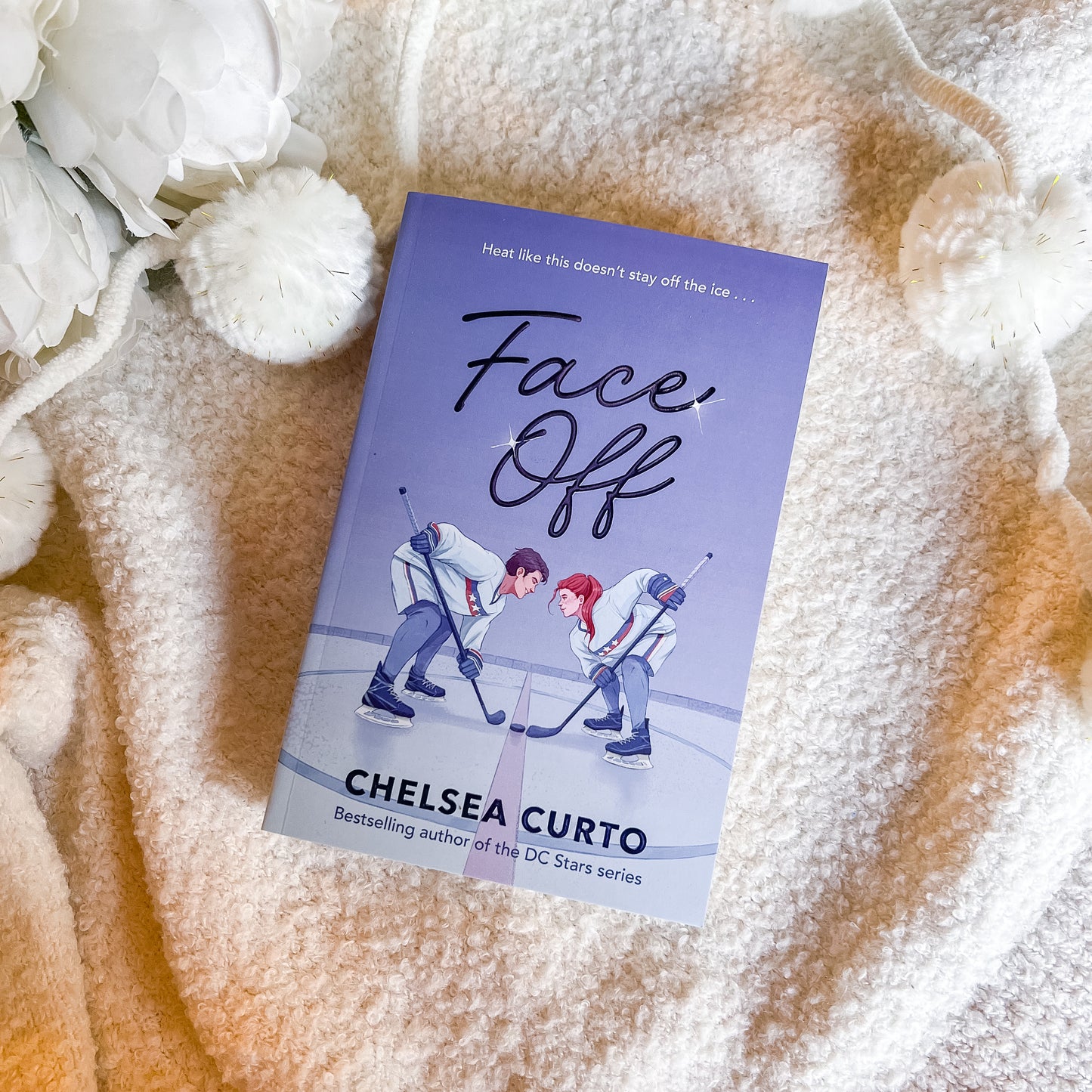 Book titled 'Face Off' by Chelsea Curto on a textured surface with flowers.