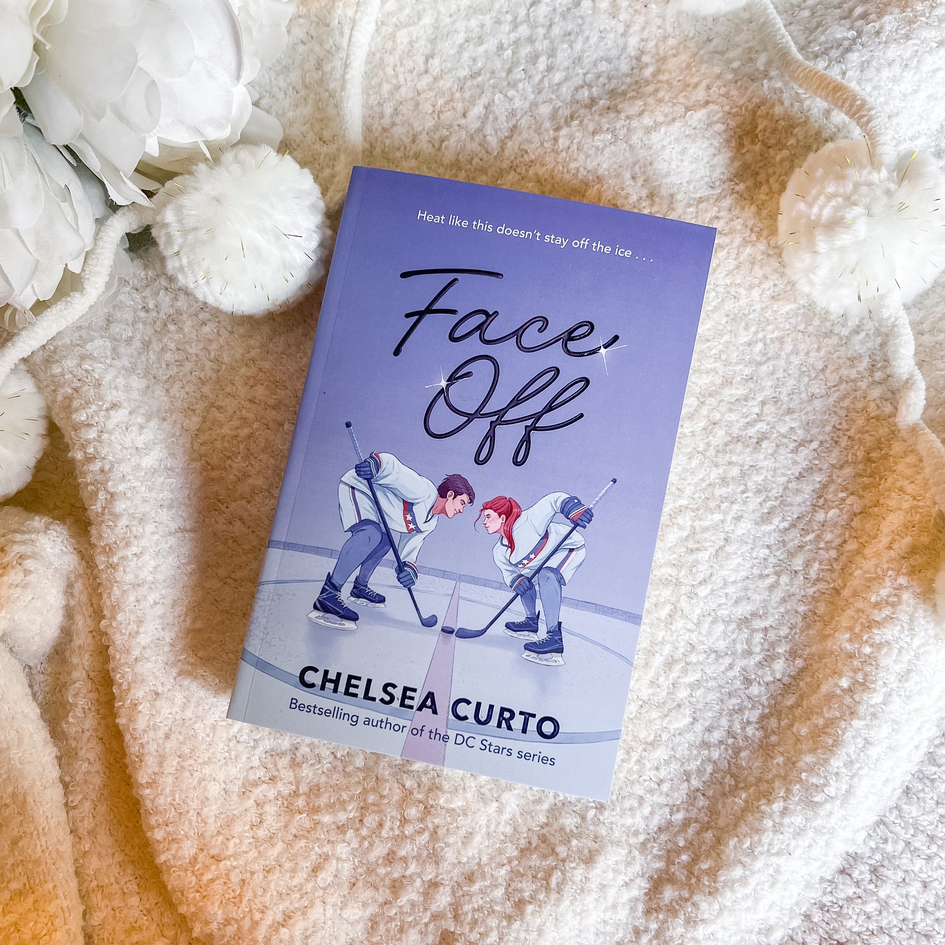 Book titled 'Face Off' by Chelsea Curto on a textured surface with flowers.