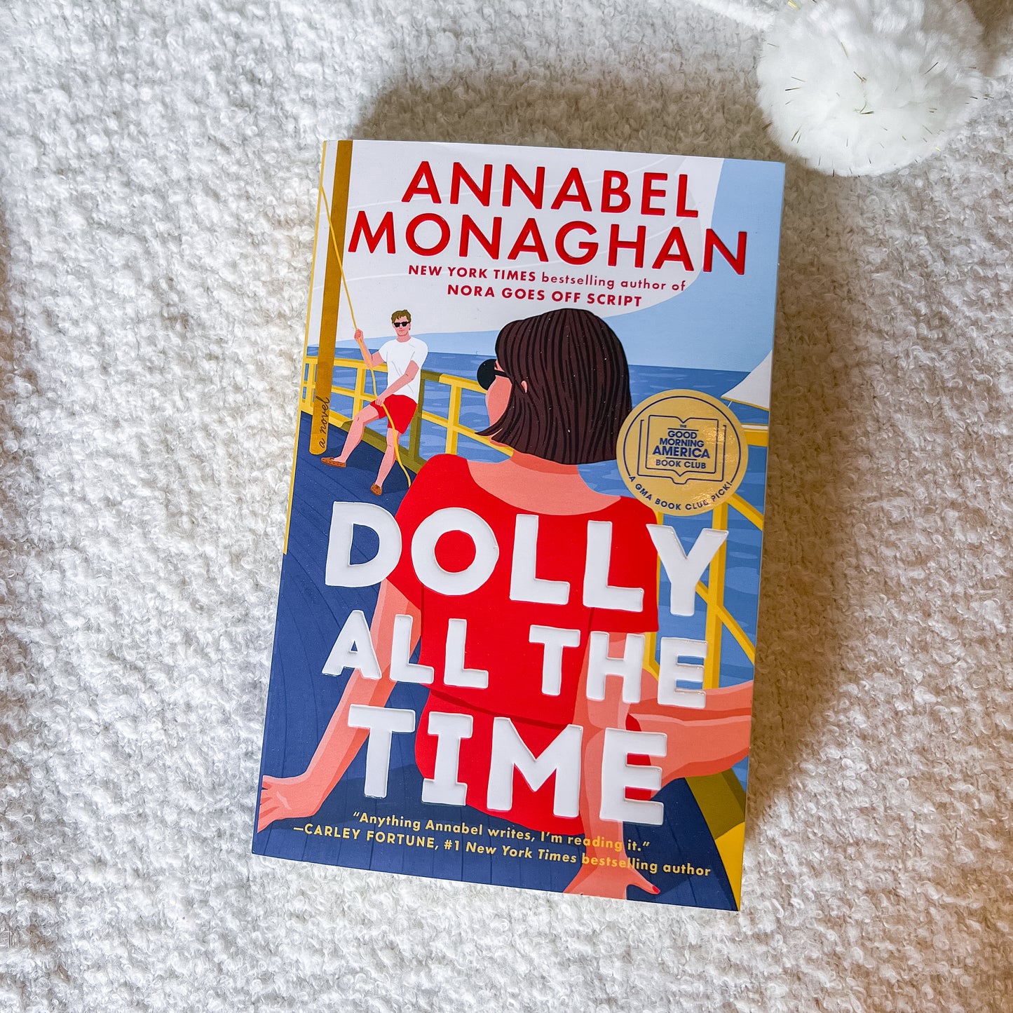 Book titled 'Dolly All The Time' by Annabel Monaghan on a textured surface.