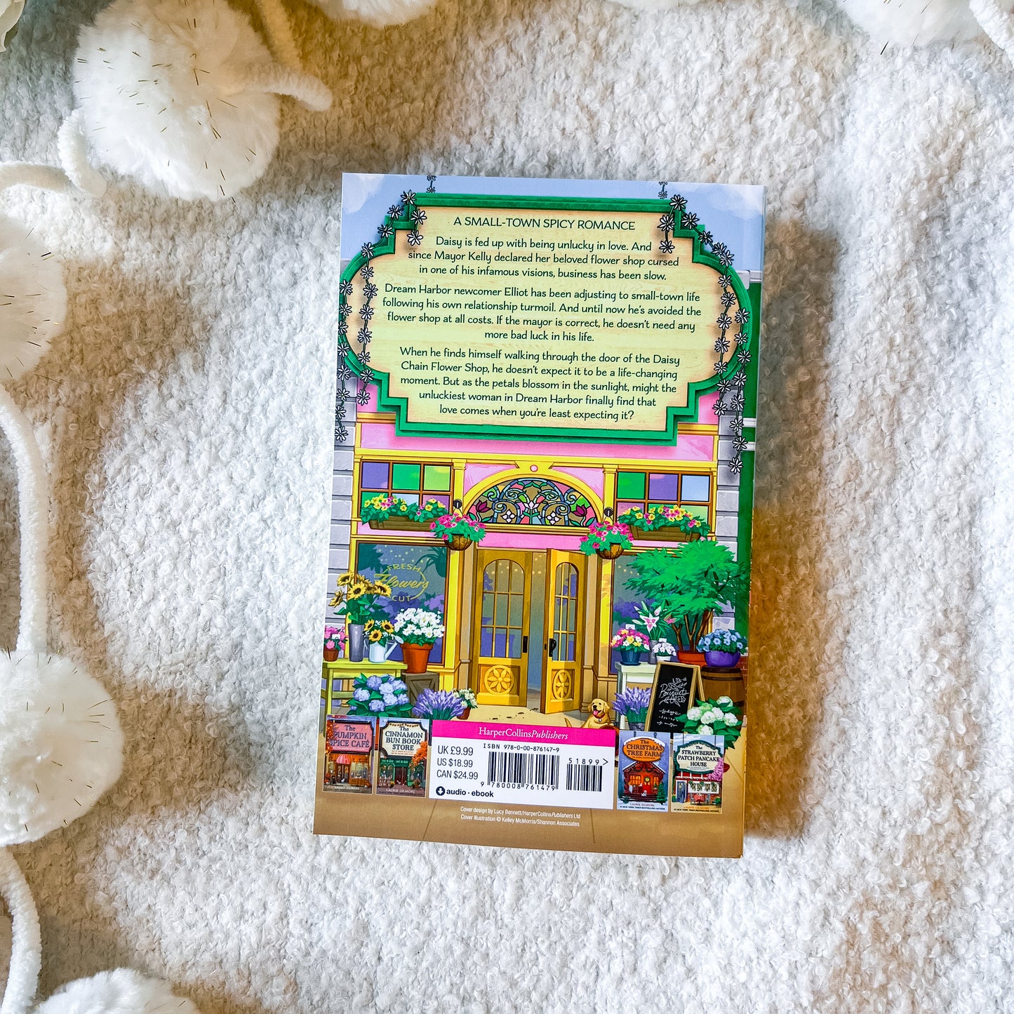 Back of the book "the daisy chain flower shop" on a textured white background
