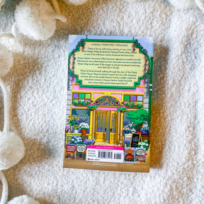 Back of the book "the daisy chain flower shop" on a textured white background