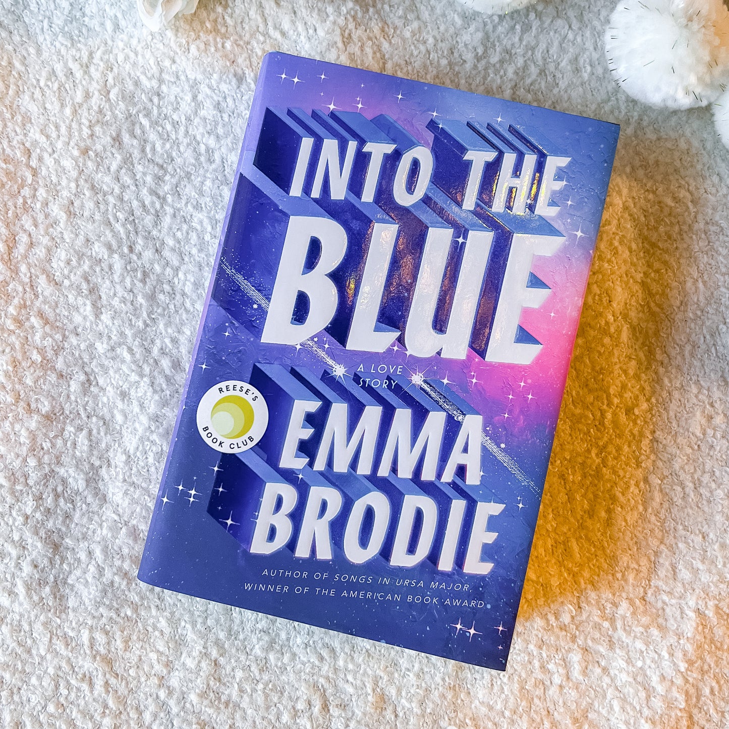 Book titled 'Into the Blue' by Emma Brodie on a textured surface