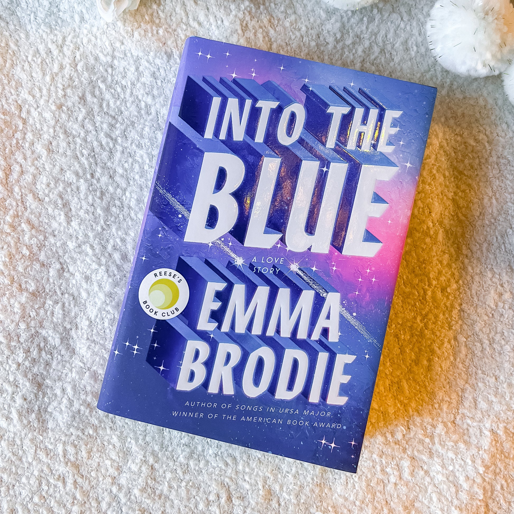 Book titled 'Into the Blue' by Emma Brodie on a textured surface