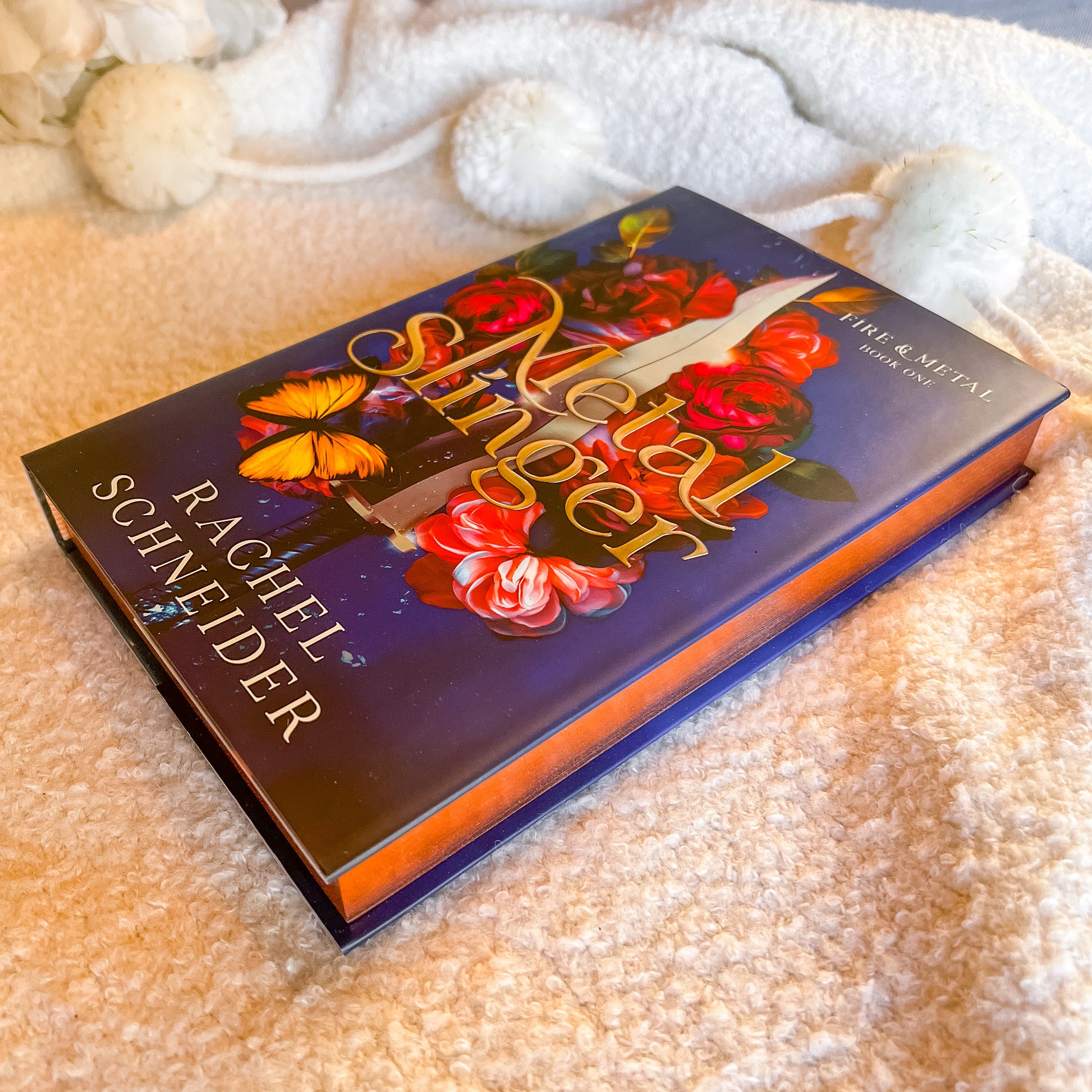 Book titled 'Metal Angel' by Rachel Schneider on a textured surface