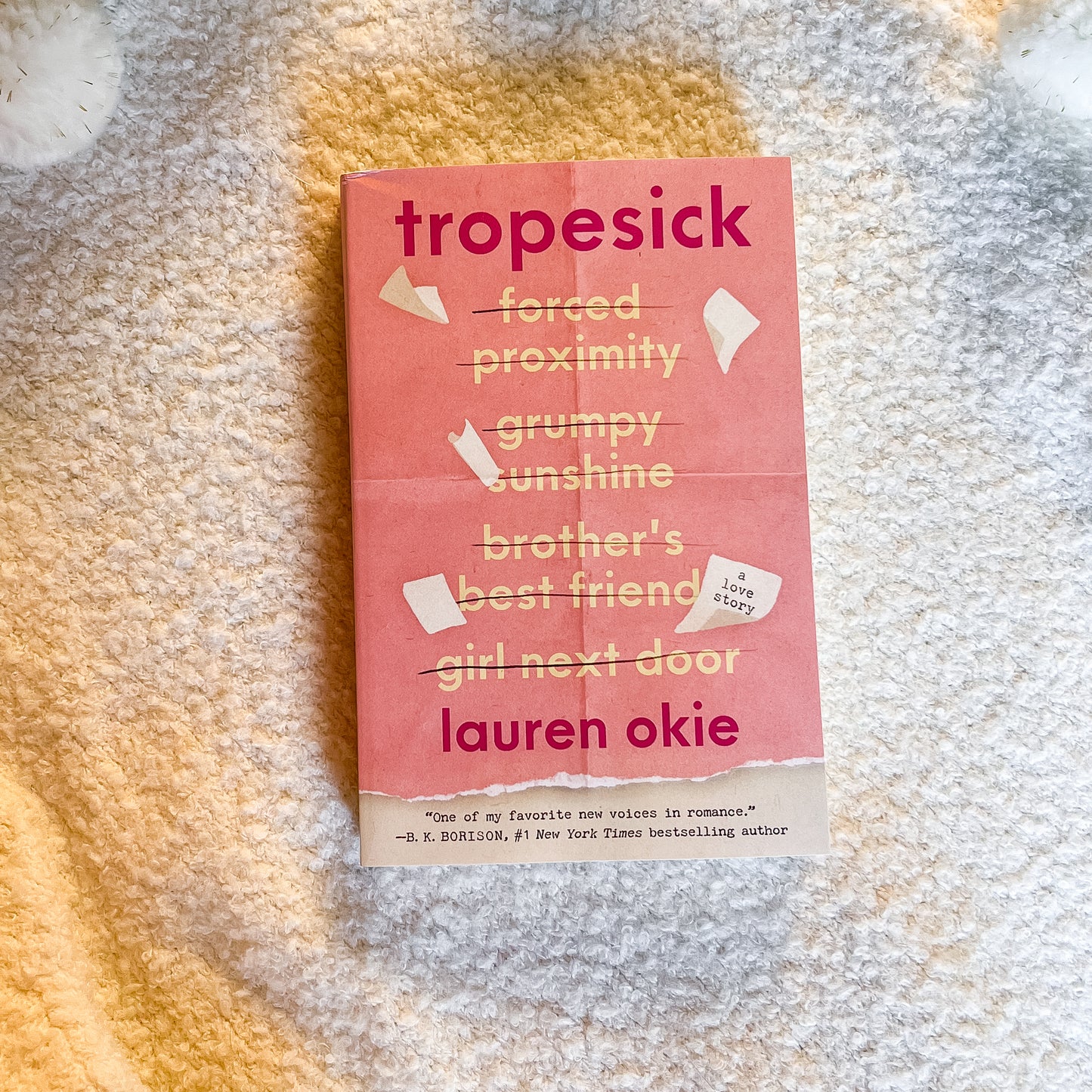 Book titled 'tropesick' by Lauren Okie on a textured surface