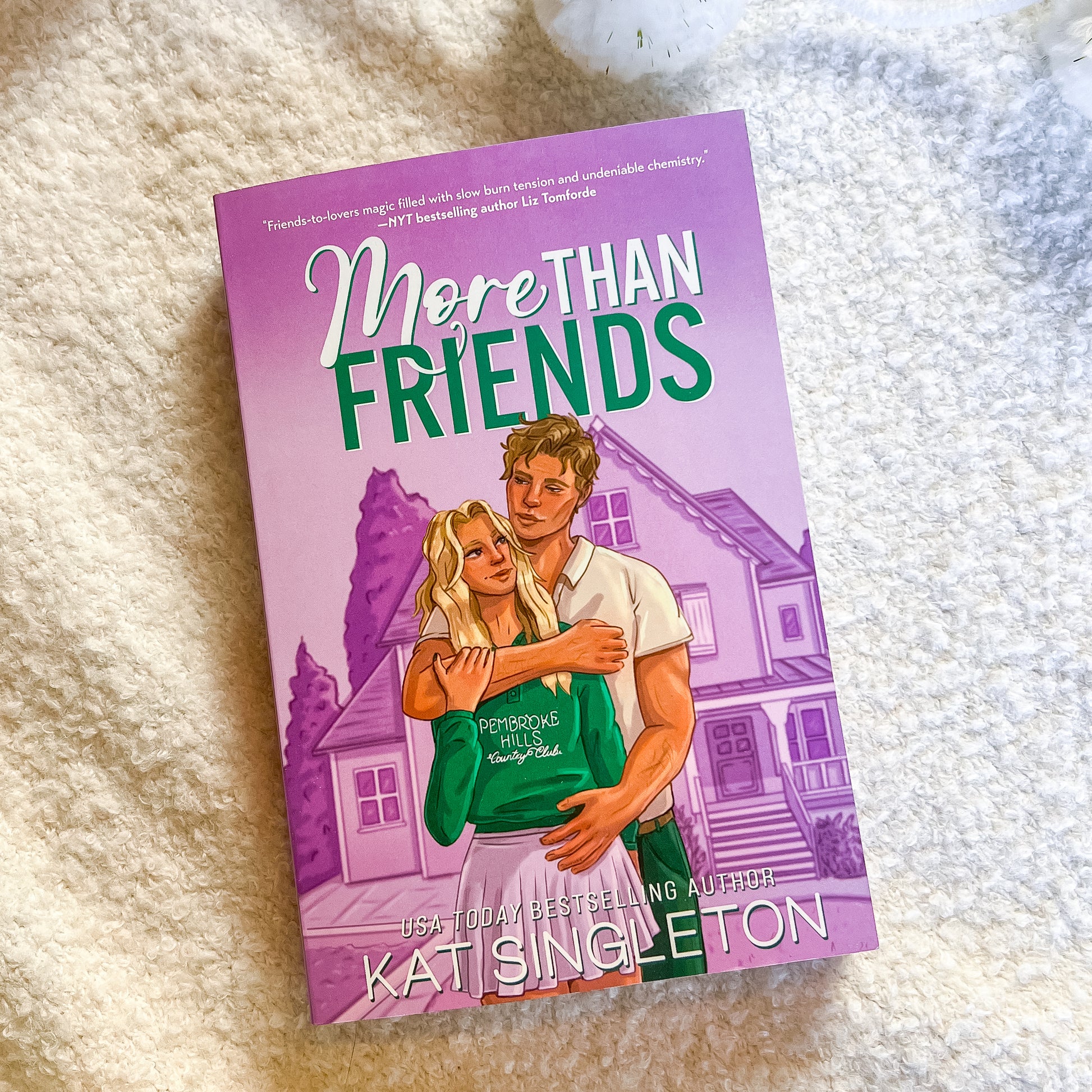 Book titled 'More Than Friends' by Kats Singleton on a textured surface