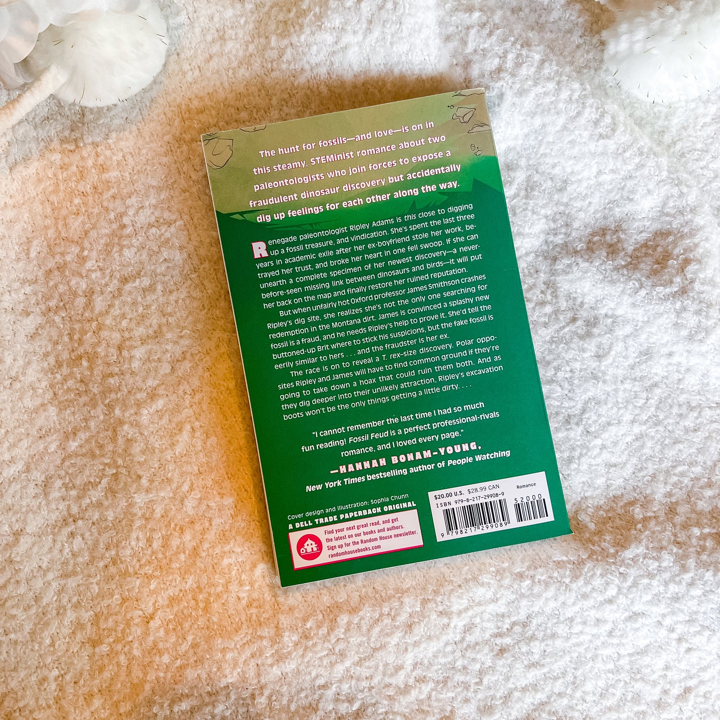 The back cover of a book, displayed flat on a textured white blanket.