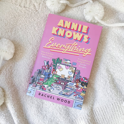 Book titled 'Annie Knows Everything' by Rachel Wood on a soft, light-colored surface.