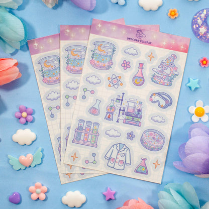 Sticker sheets with science-themed designs on a blue background with decorative elements.