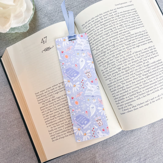 Blue bookmark with a ghost design on top of a book