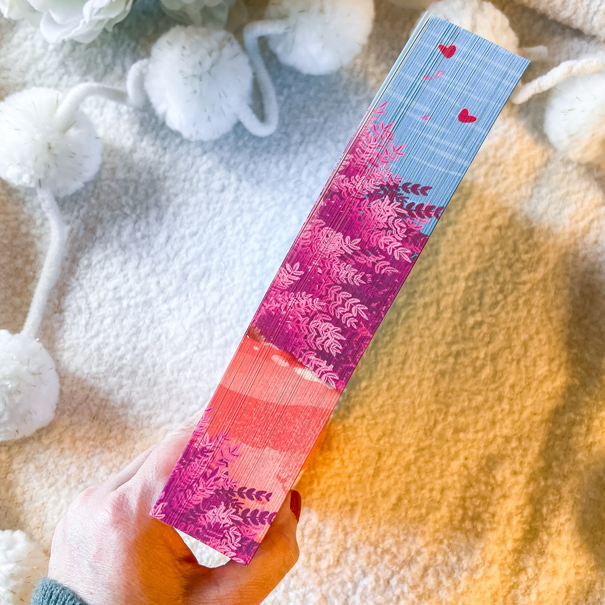The sprayed edges of the book "rules for the summer" on a textured white background.