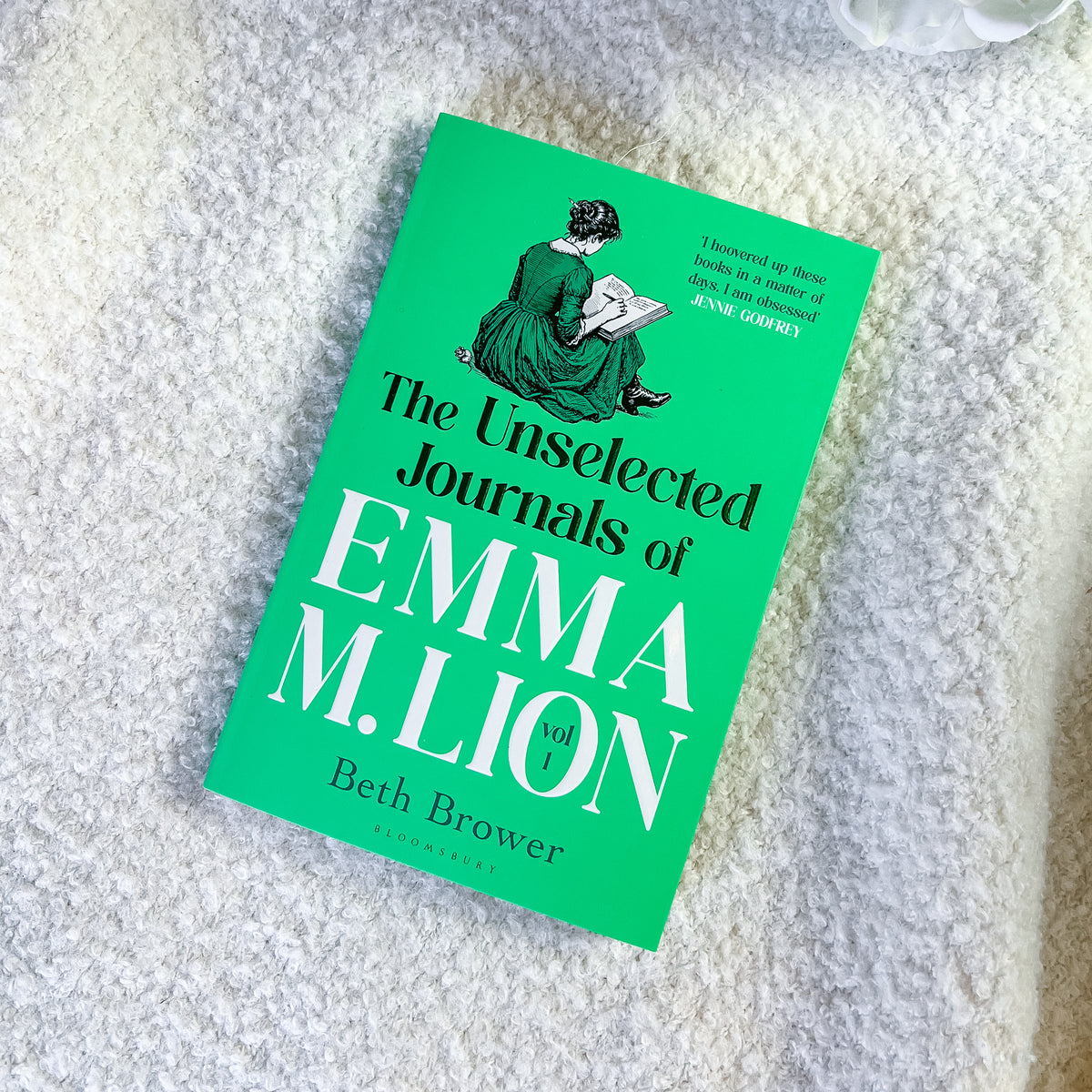 The book 'The Unselected Journals of Emma M. Lion' by Beth Brower, published by Allen & Unwin, shown on a textured white blanket.