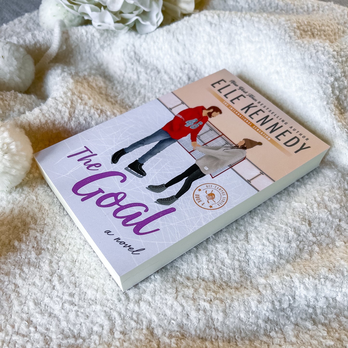 Book titled 'The Goal' by Elle Kennedy on a soft blanket