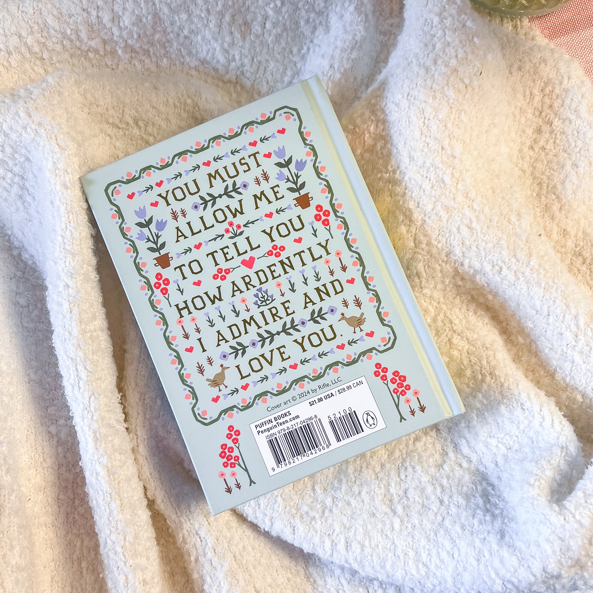 Book with decorative cover on a soft fabric background