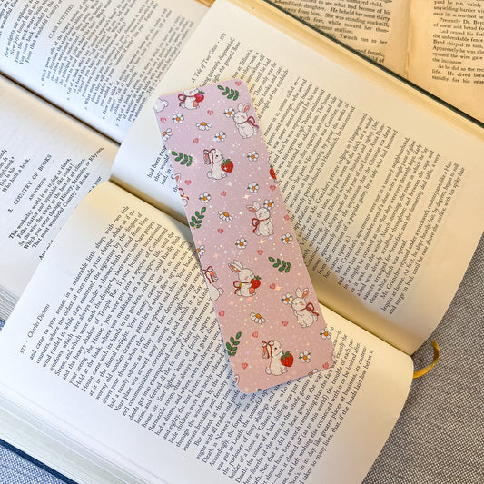 Pink bookmark with cartoon characters on an open book