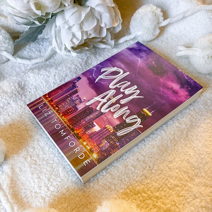 Cover of play along by liz tomforde on a soft white background