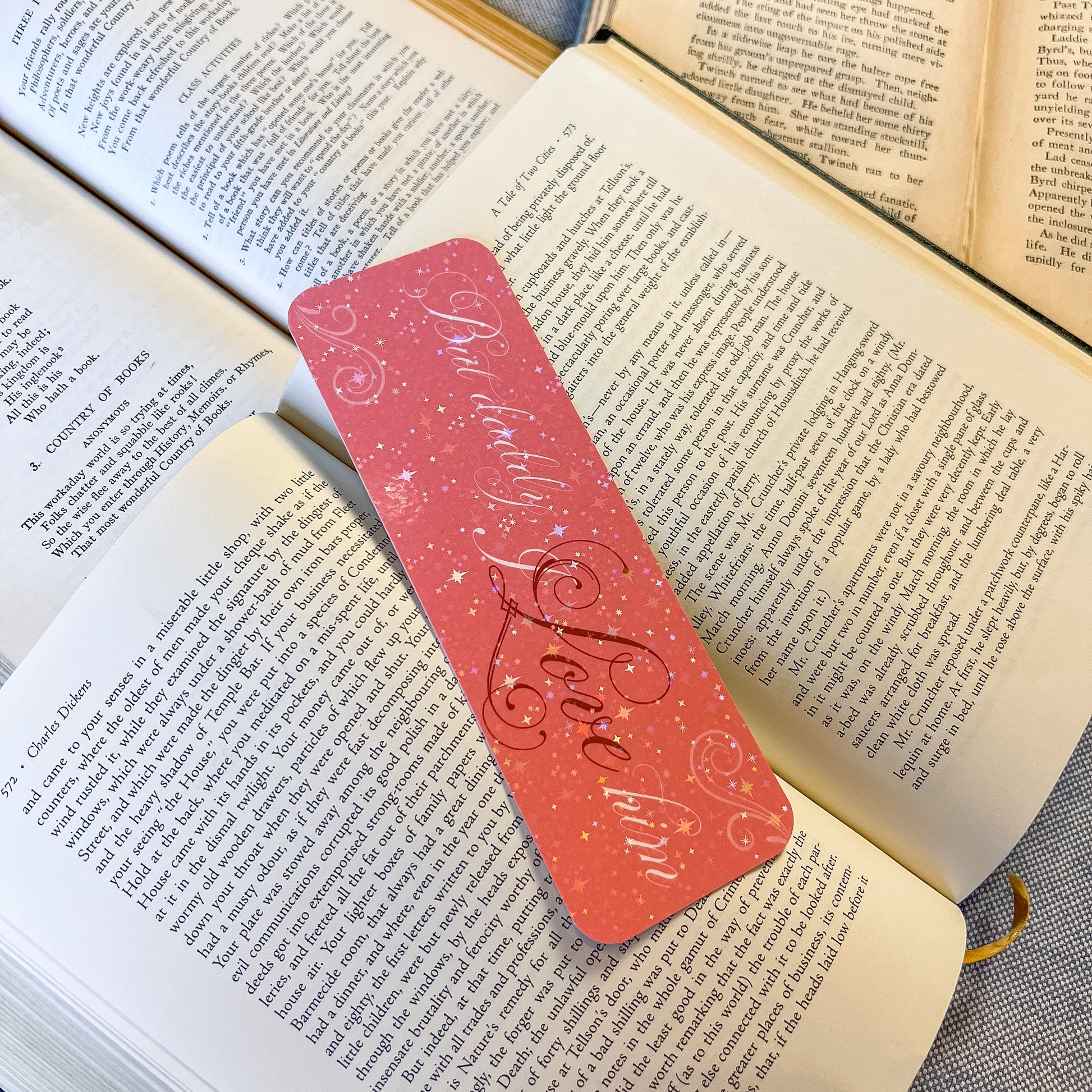 Pink bookmark with 'Beloved Love' text on an open book