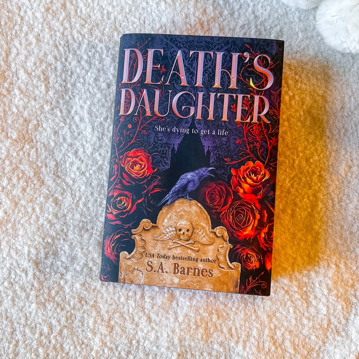 Book cover of 'Death's Daughter' with roses and a gravestone design on a white background