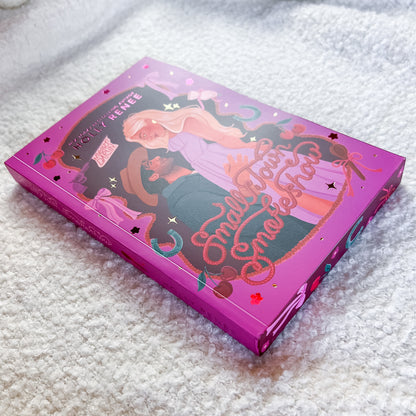 Book by Holly Renee, photographed on a soft white textured blanket.
