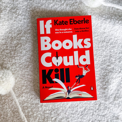 The book cover of 'If Books Could Kill' by Kate Eberle is displayed flat on a textured white blanket. The cover is predominantly bright red with bold white and black typography, featuring an illustration of a person falling off an open book.