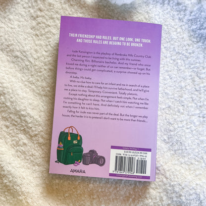Book back cover with text and a green bag illustration on a textured surface