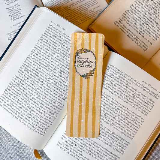 Wooden bookmark with 'Sunshine Books' design on an open book