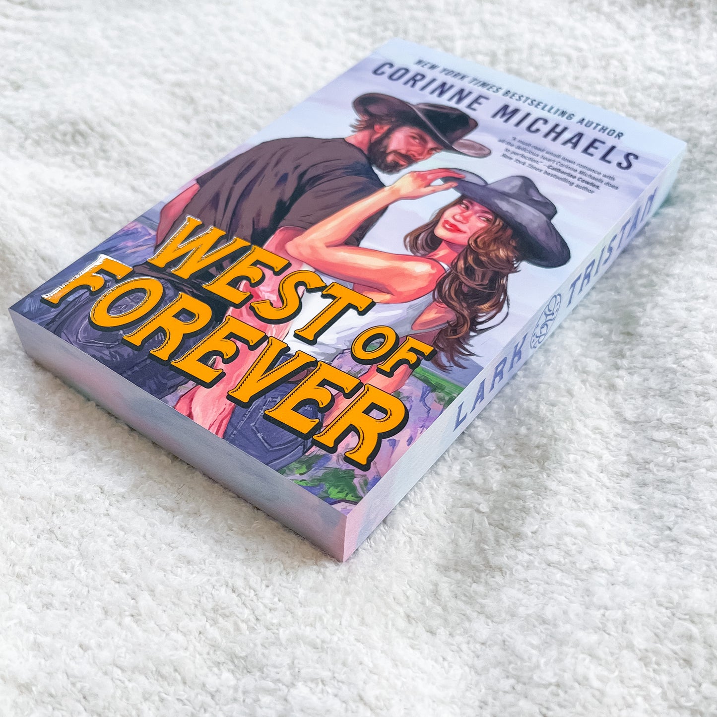 Book titled 'West of Forever' by Corinne Michaels on a textured white surface