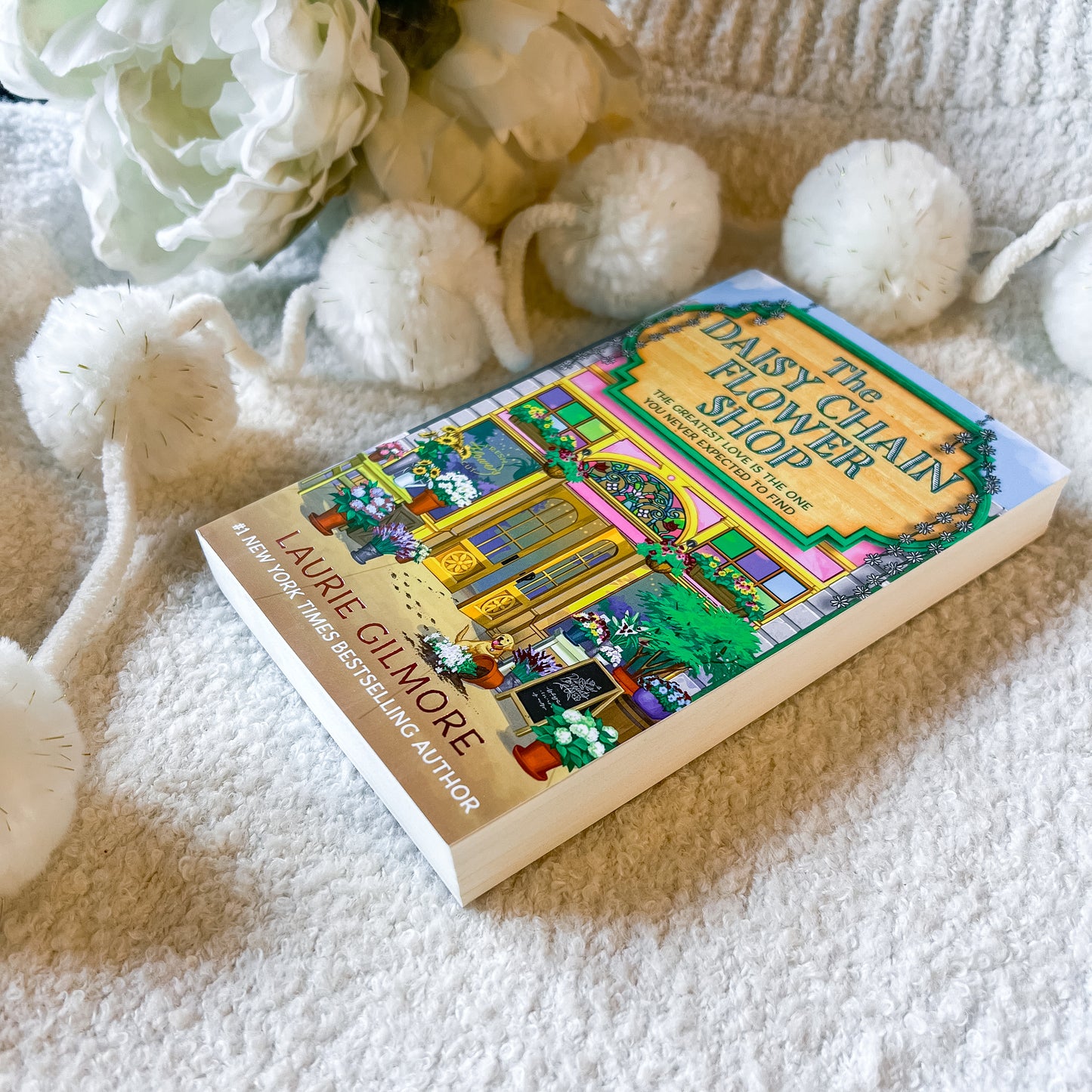 Book "the daisy chain flower shop" on a textured white background
