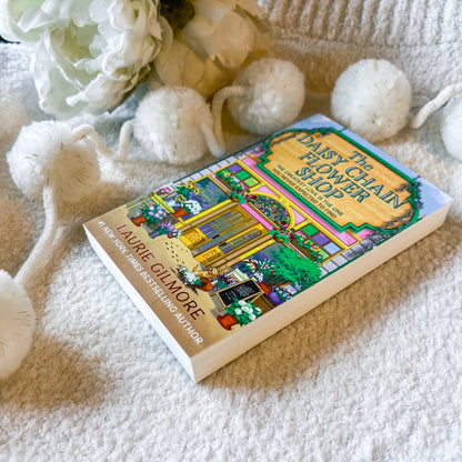Book "the daisy chain flower shop" on a textured white background