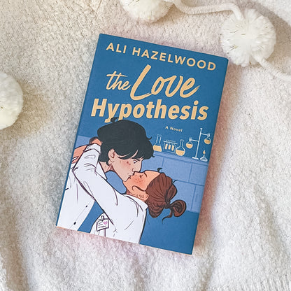 Book titled 'The Love Hypothesis' by Ali Hazelwood on a soft, light-colored surface.