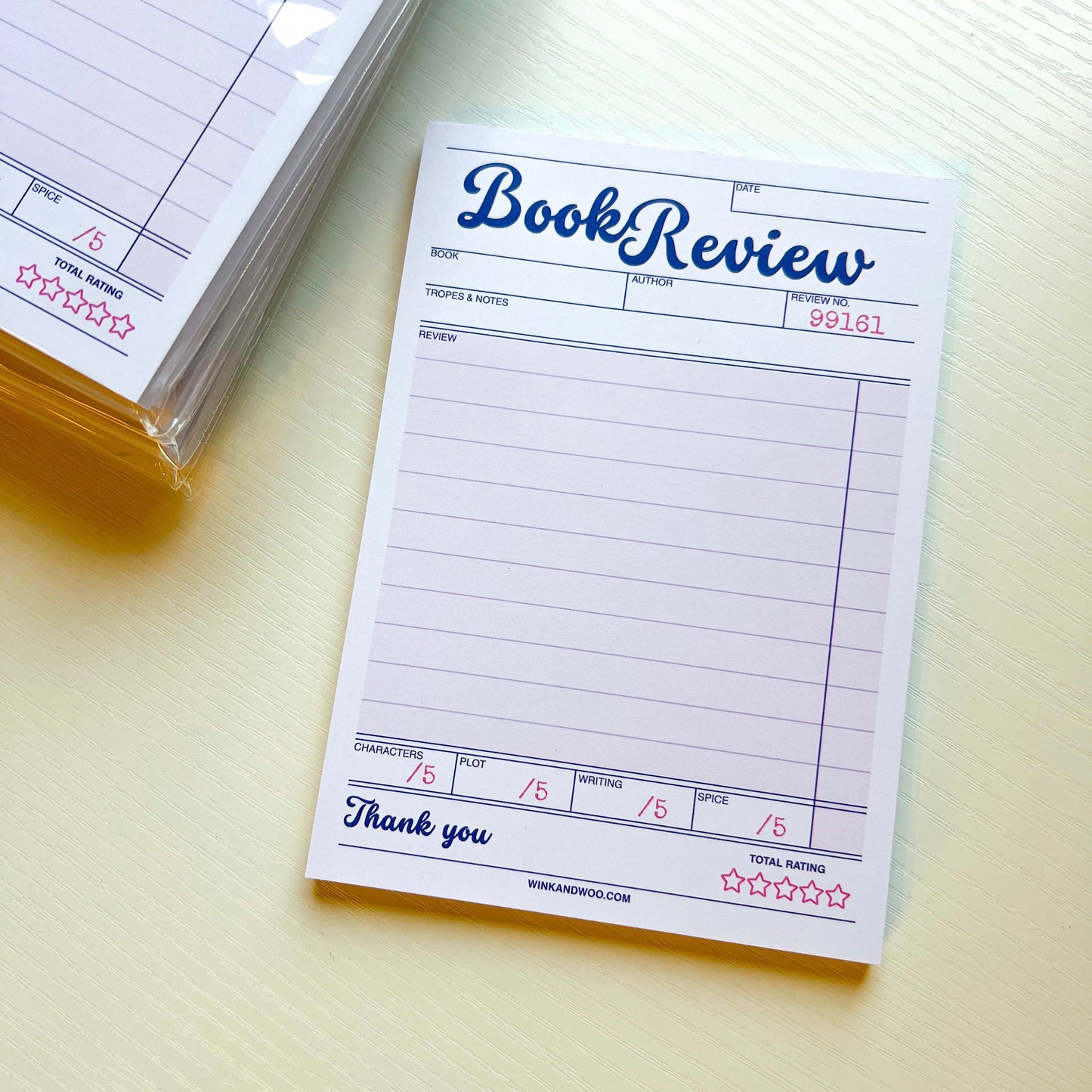 Book review notepad on a light surface