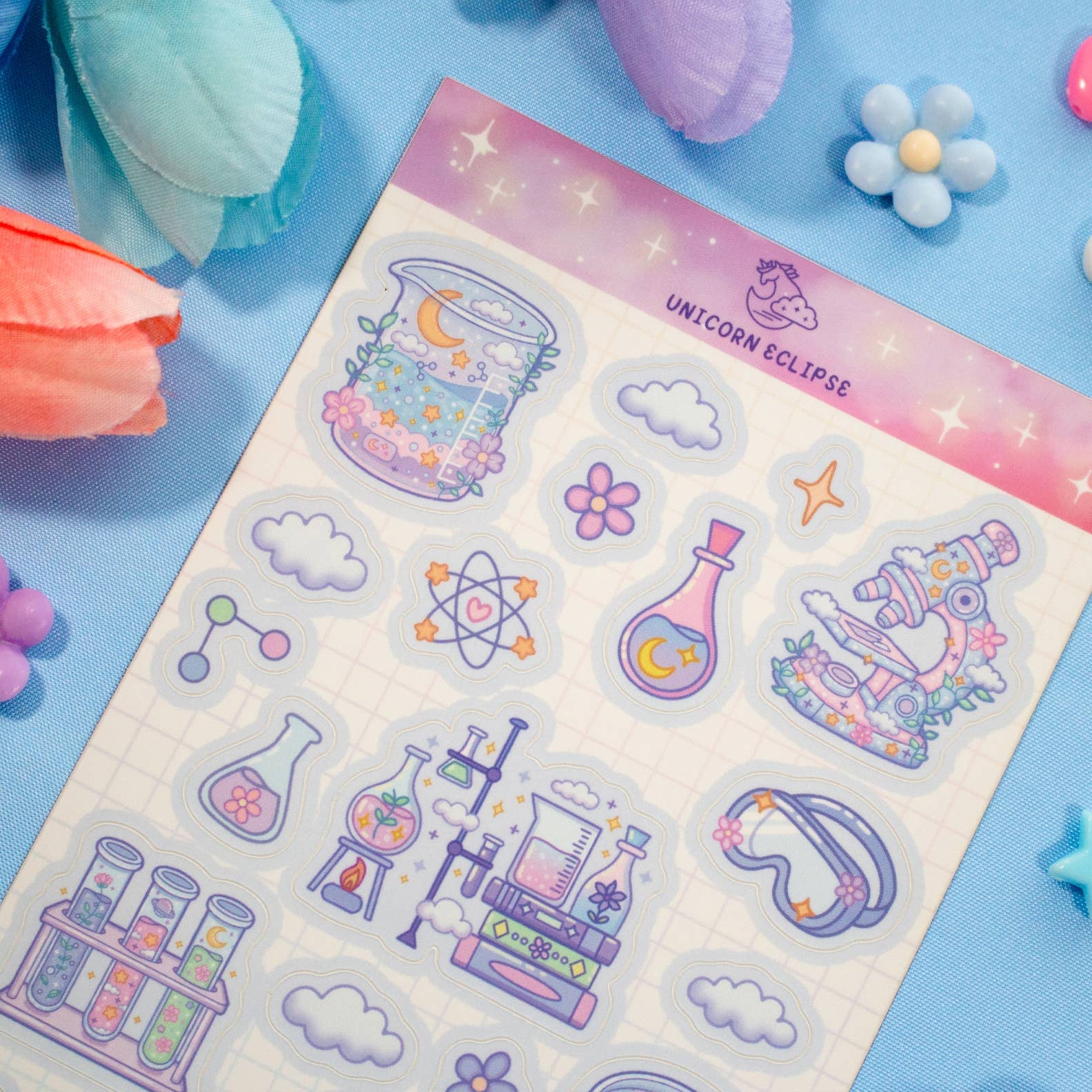 Sheet of colorful stickers with various designs on a blue background with decorative items.