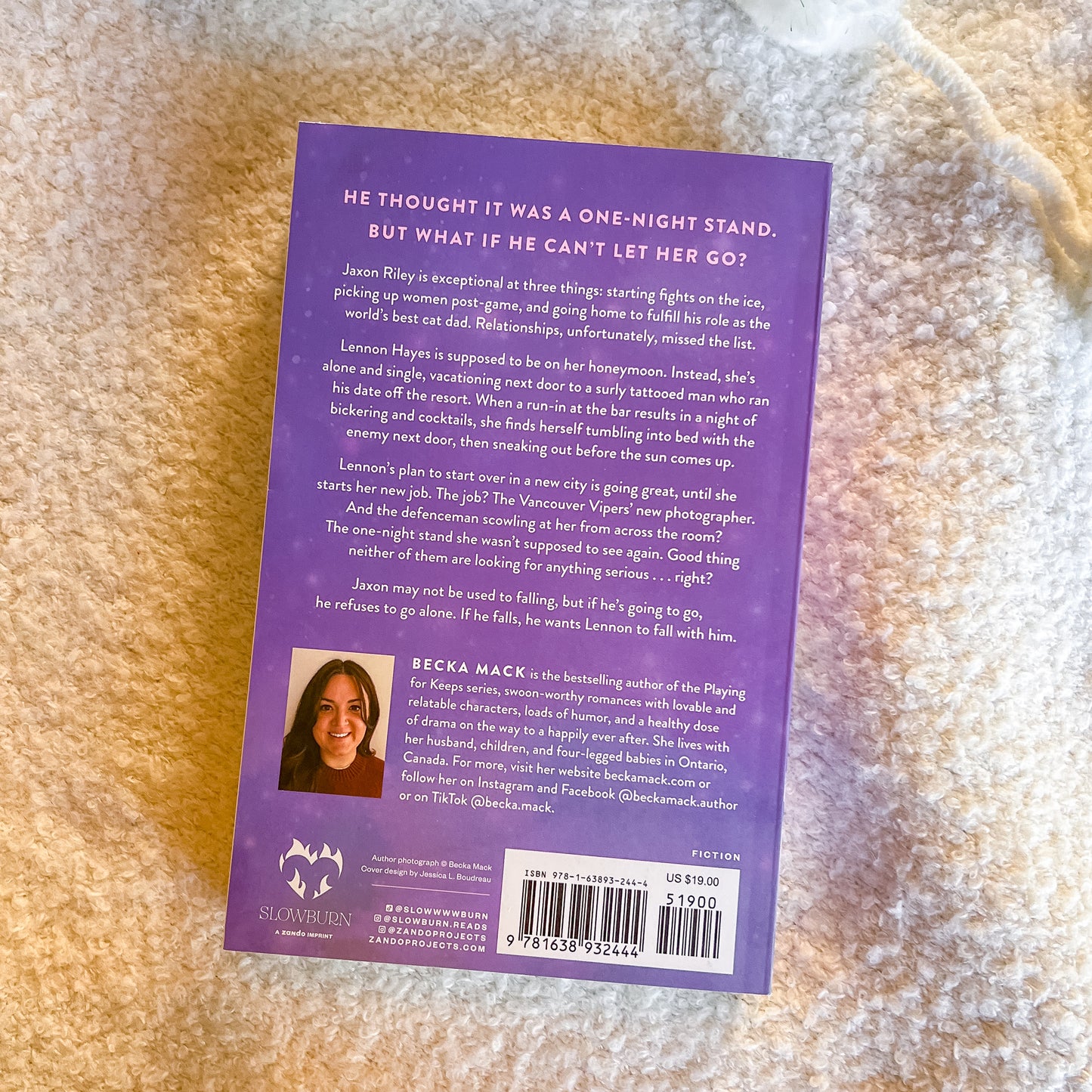 Back cover of a book with text and a barcode on a textured surface