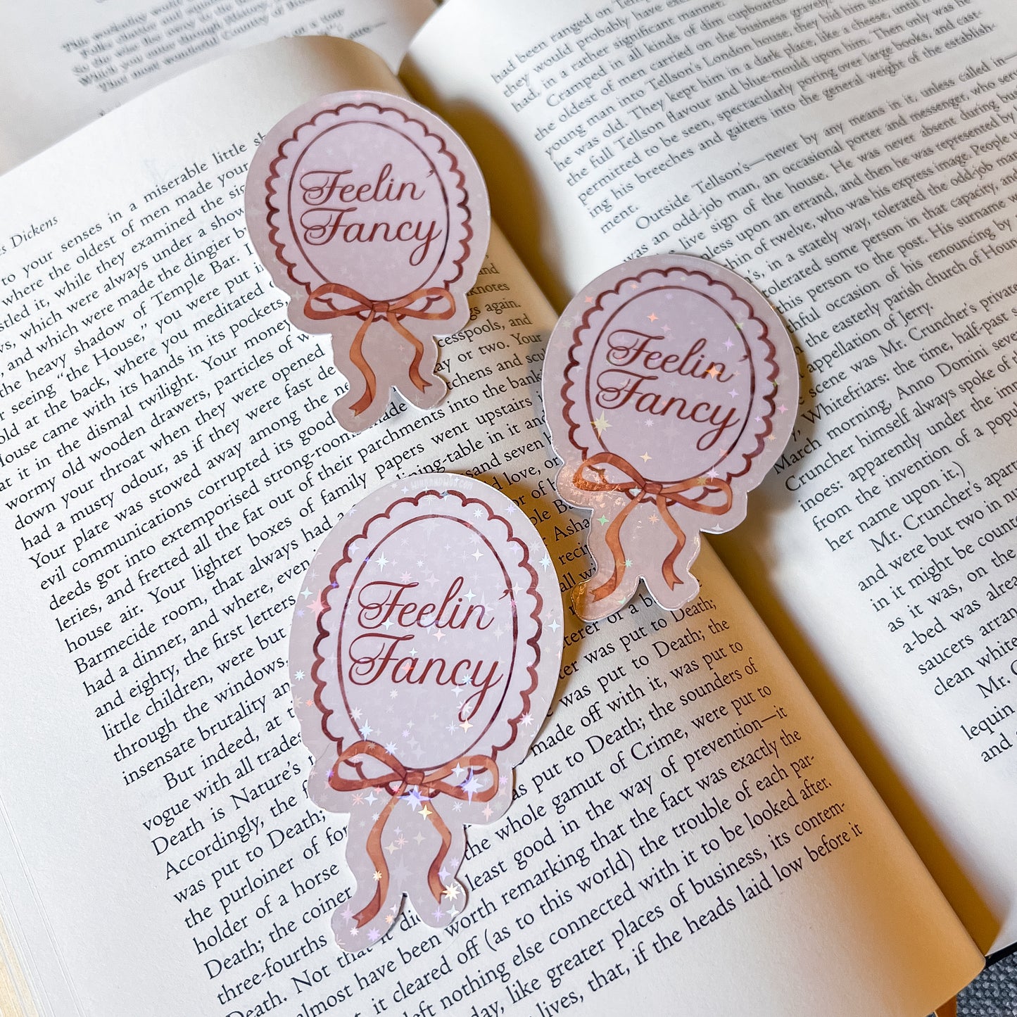 Three 'Feelin' Fancy' stickers on an open book