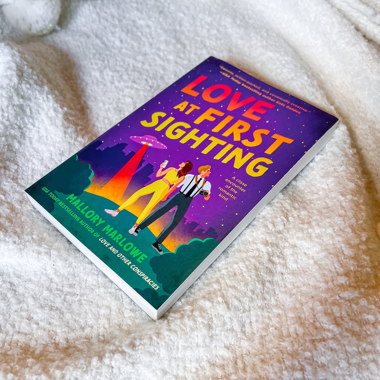 Book titled 'Love at First Sighting' by Mallory Marlowe on a textured surface