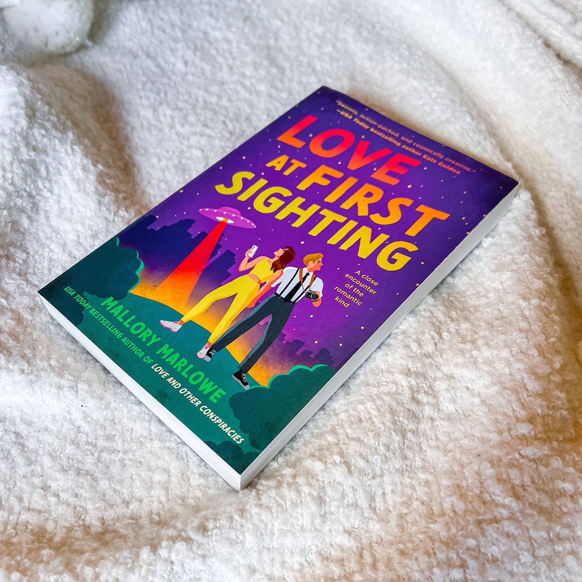 Book titled 'Love at First Sighting' by Mallory Marlowe on a textured surface