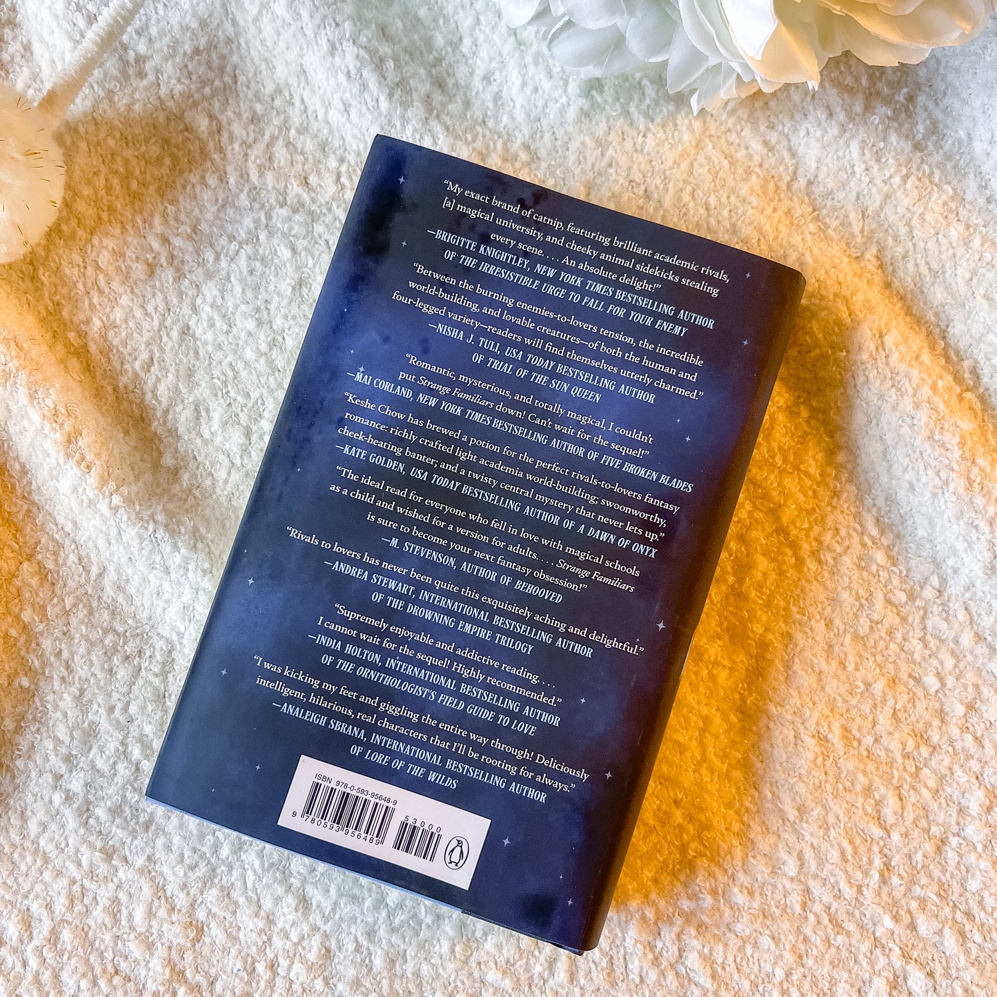 Book with text and a barcode on a textured surface with flowers