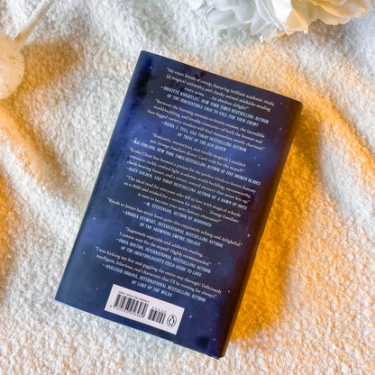 Book with text and a barcode on a textured surface with flowers