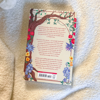 Book cover with floral design and text on a textured surface