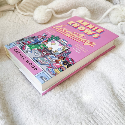 Book titled 'Annie Knows Everything' by Rachel Wood on a soft white surface