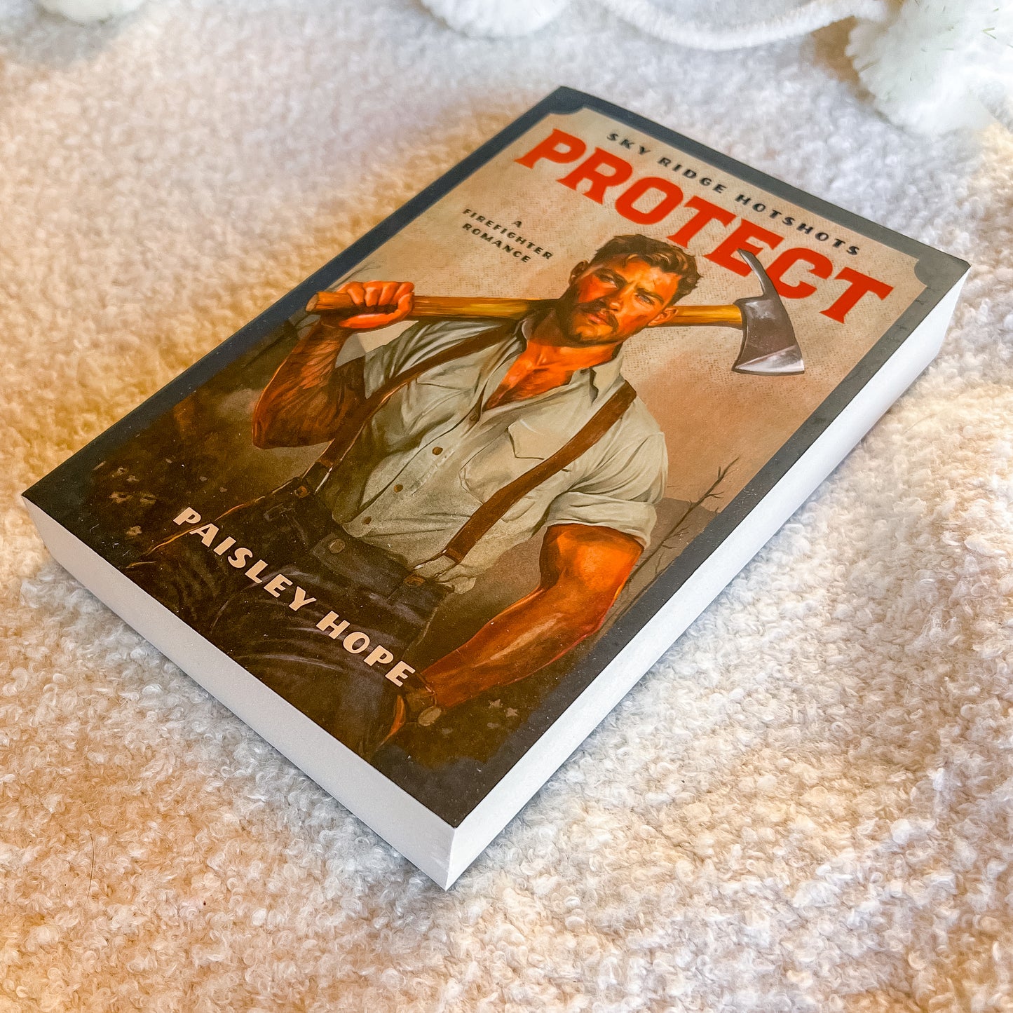 Book titled 'PROTECT' by Paisley Hope on a textured surface