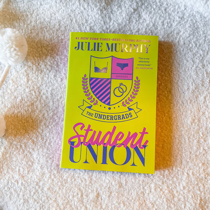 Book cover of 'The Undergrads Student Union' by Julie Murphy with a yellow and pink design.